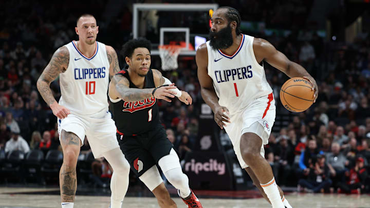Mar 20, 2024; Portland, Oregon, USA;  LA Clippers guard James Harden (1) dribbles past Portland Trail Blazers guard Anfernee Simons (1) as Clippers center Daniel Theis (10) watches in the second quarter at Moda Center. Mandatory Credit: Jaime Valdez-Imagn Images