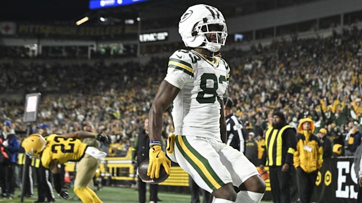 Green Bay Packers wide receiver Savion Williams (83) scores a touchdown against the Pittsburgh Steelers during the third quarter at Acrisure Stadium.