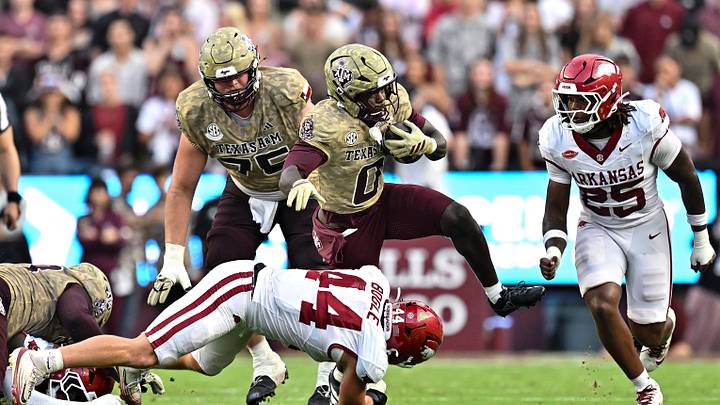 Texas A&M Aggies running back KJ Edwards (0) runs the ball as Arkansas Razorbacks linebacker Ben Bogle (44) attempts a tackle during the first half at Kyle Field. Texas A&M Aggies running back KJ Edwards (0) runs the ball as Arkansas Razorbacks linebacker Ben Bogle (44) attempts a tackle during the first half at Kyle Field.