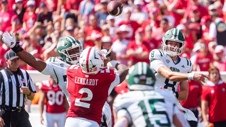 Ohio quarterback Nick Poulos fires a pass as the Huskers' Cam Lenhardt applies pressure. Ohio quarterback Nick Poulos fires a pass as the Huskers' Cam Lenhardt applies pressure.