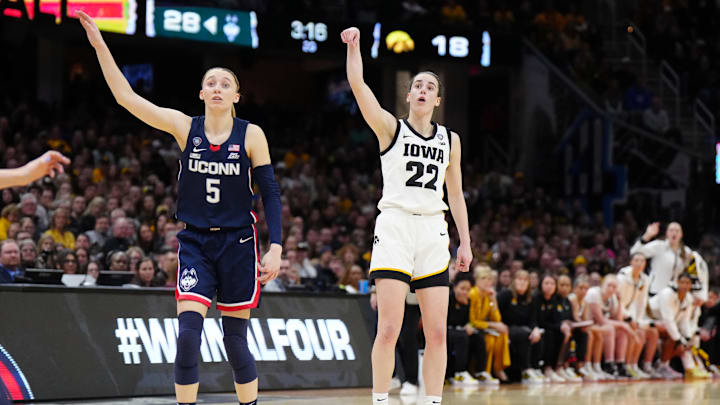 Apr 5, 2024; Cleveland, OH, USA; Iowa Hawkeyes guard Caitlin Clark (22) and Connecticut Huskies guard Paige Bueckers (5) react in the second quarter in the semifinals of the Final Four of the womens 2024 NCAA Tournament at Rocket Mortgage FieldHouse. Mandatory Credit: Kirby Lee-Imagn Images