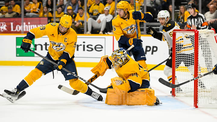 Oct 22, 2024; Nashville, Tennessee, USA;  Nashville Predators goaltender Juuse Saros (74) blocks a shot against the Boston Bruins during the second period at Bridgestone Arena. Mandatory Credit: Steve Roberts-Imagn Images