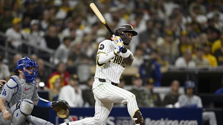 Oct 9, 2024; San Diego, California, USA; San Diego Padres outfielder Jurickson Profar (10) singles in the eighth inning against the Los Angeles Dodgers during game four of the NLDS for the 2024 MLB Playoffs at Petco Park.  Mandatory Credit: Denis Poroy-Imagn Images