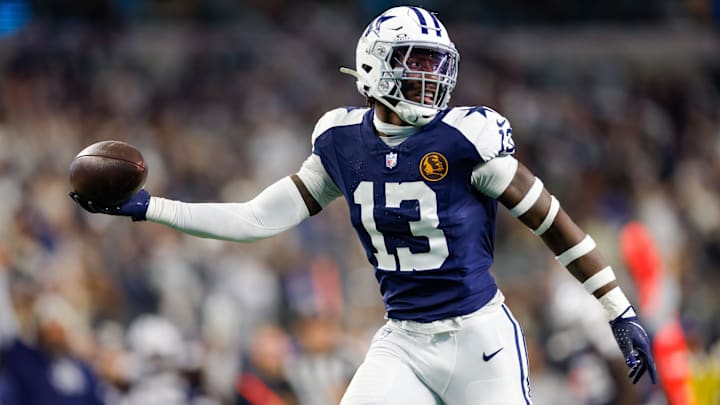 Dallas Cowboys linebacker DeMarvion Overshown (13) intercepts a pass and returns it for a touchdown during the second quarter against the New York Giants at AT&T Stadium.
