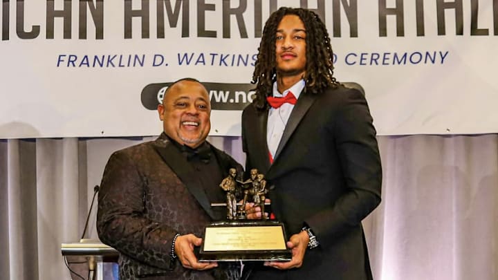 Malik Washington receiving the 2025 Watkins Award from Everette Pearsall, Executive Director & Founder of the National Alliance of African American Athletes. 