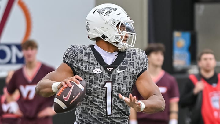 Nov 22, 2025; Blacksburg, Virginia, USA;  Virginia Tech Hokies quarterback Kyron Drones (1) looks to pass against the Miami (FL) Hurricanes during the fourth quarter at Lane Stadium. Mandatory Credit: Brian Bishop-Imagn Images