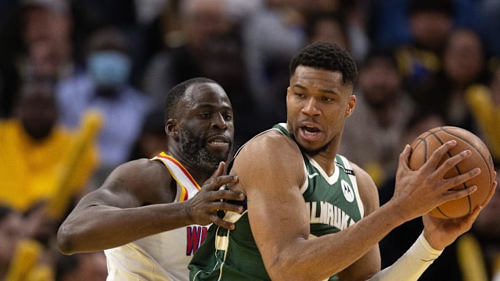 Mar 18, 2025; San Francisco, California, USA; Milwaukee Bucks forward Giannis Antetokounmpo (34) attempts to turn and shoot over Golden State Warriors forward Draymond Green (left) during the fourth quarter at Chase Center. Mandatory Credit: D. Ross Cameron-Imagn Images