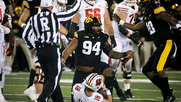 Iowa defensive lineman Yahya Black (94) tackled Wisconsin quarterback Braedyn Locke (18) in the Saturday, Nov. 2, 2024 at Kinnick Stadium in Iowa City, Iowa.