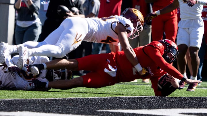 Cincinnati Bearcats quarterback Brendan Sorsby (2) dives for a touchdown as Arizona State Sun Devils defensive back Xavion Alford (2) and Arizona State Sun Devils linebacker Keyshaun Elliott (44) attempt to stop him in the first quarter of the College Football game at Nippert Stadium in Cincinnati on Saturday, Oct. 19, 2024.