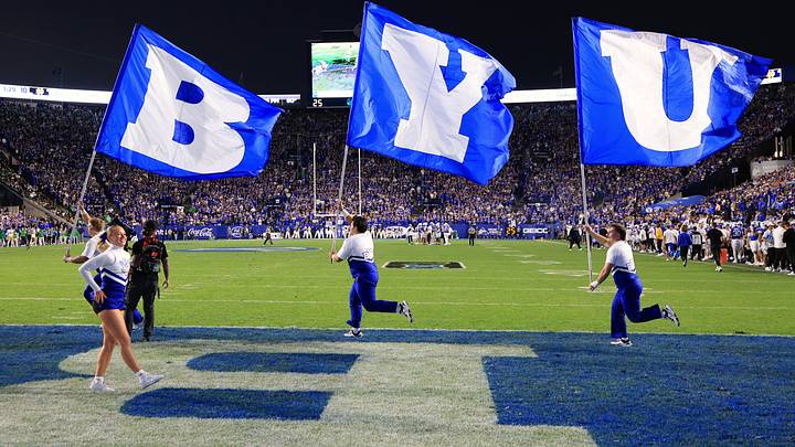 Oct 17, 2026; Provo, Utah, USA;  Brigham Young Cougars cheerleaders celebrate with flags on the field during the first half against the Notre Dame Fighting Irish at LaVell Edwards Stadium.  Mandatory Credit: Rob Gray-Imagn Images