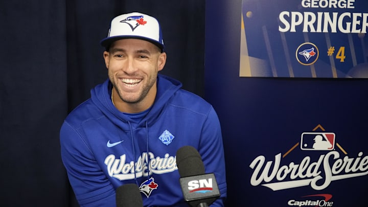 Toronto Blue Jays designated hitter George Springer (4) smiles after a question at the World Series media day interviews at Rogers Centre. Toronto Blue Jays designated hitter George Springer (4) smiles after a question at the World Series media day interviews at Rogers Centre.