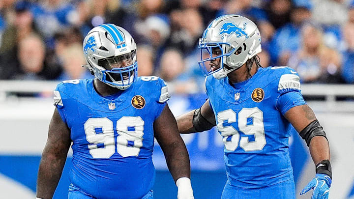 Detroit Lions defensive tackle DJ Reader (98) and linebacker Al-Quadin Muhammad (69) celebrates a play against Chicago Bears during the second half at Ford Field in Detroit on Thursday, Nov. 28, 2024.