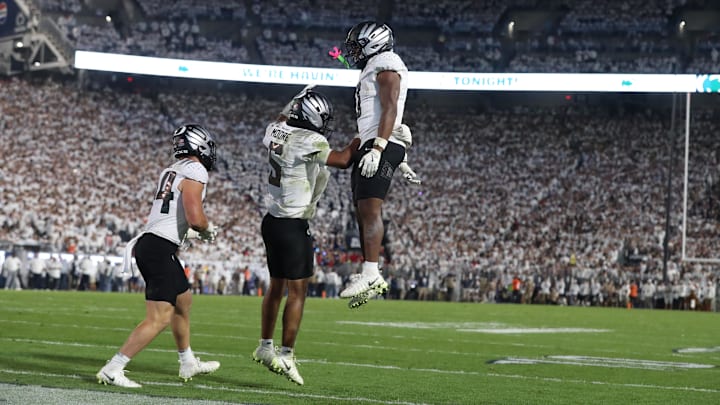 Sep 27, 2025; University Park, Pennsylvania, USA; Oregon Ducks running back Jordon Davison (0) reacts with quarterback Dante Moore (5) after scoring a touchdown against the Penn State Nittany Lions at Beaver Stadium. Mandatory Credit: Matthew O'Haren-Imagn Images