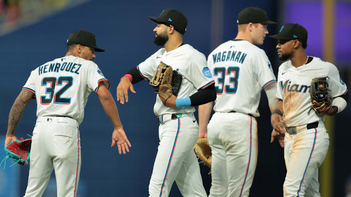Jul 3, 2025; Miami, Florida, USA; Miami Marlins center fielder Derek Hill (3) celebrates with relief pitcher Ronny Henriquez (32) after the game against the Minnesota Twins at loanDepot Park. Mandatory Credit: Sam Navarro-Imagn Images