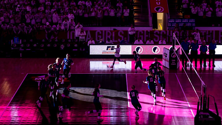 Ankeny Christian Eagles players are illuminated by a spotlight while being introduced during the Class 1A IGHSAU Iowa Girls High School Athletic Union state volleyball championship match between Ankeny Christian and Holy Trinity Catholic, Thursday, Nov. 2, 2023, at Xtream Arena in Coralville, Iowa.