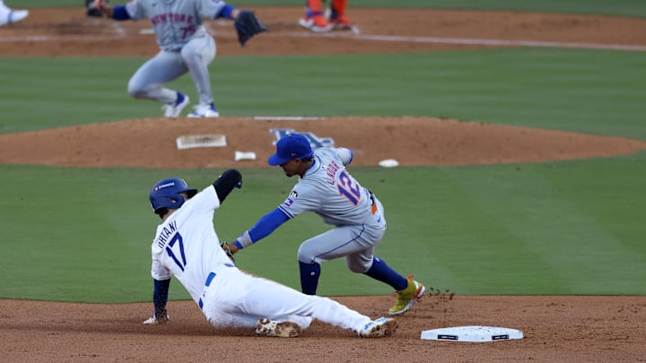 Oct 13, 2024; Los Angeles, California, USA; New York Mets shortstop Francisco Lindor (12) tags out Los Angeles Dodgers two-way player Shohei Ohtani (17) attempting to steal second base in the second inning during game one of the NLCS for the 2024 MLB Playoffs at Dodger Stadium. Mandatory Credit: Jason Parkhurst-Imagn Images Oct 13, 2024; Los Angeles, California, USA; New York Mets shortstop Francisco Lindor (12) tags out Los Angeles Dodgers two-way player Shohei Ohtani (17) attempting to steal second base in the second inning during game one of the NLCS for the 2024 MLB Playoffs at Dodger Stadium. Mandatory Credit: Jason Parkhurst-Imagn Images
