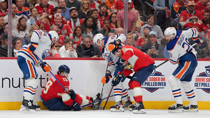 Jun 17, 2025; Sunrise, Florida, USA; Florida Panthers left wing Matthew Tkachuk (19) falls to the ice against the Edmonton Oilers as players battle for the puck during the second period in game six of the 2025 Stanley Cup Final at Amerant Bank Arena. Mandatory Credit: Sam Navarro-Imagn Images