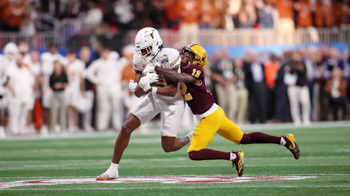 Jan 1, 2025; Atlanta, GA, USA; Texas Longhorns wide receiver Ryan Wingo (5) runs with the ball against Arizona State Sun Devils defensive back Javan Robinson (12) during the second half of the Peach Bowl at Mercedes-Benz Stadium. Mandatory Credit: Brett Davis-Imagn Images
