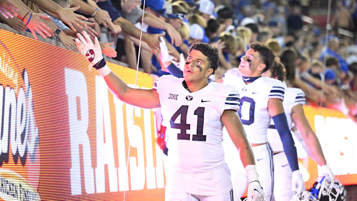 Sep 6, 2024; Dallas, Texas, USA; Brigham Young Cougars linebacker Sione Moa (41) slaps hands with the fans after the Cougars win over the Southern Methodist Mustangs at Gerald J. Ford Stadium. Mandatory Credit: Jerome Miron-Imagn Images Sep 6, 2024; Dallas, Texas, USA; Brigham Young Cougars linebacker Sione Moa (41) slaps hands with the fans after the Cougars win over the Southern Methodist Mustangs at Gerald J. Ford Stadium. Mandatory Credit: Jerome Miron-Imagn Images