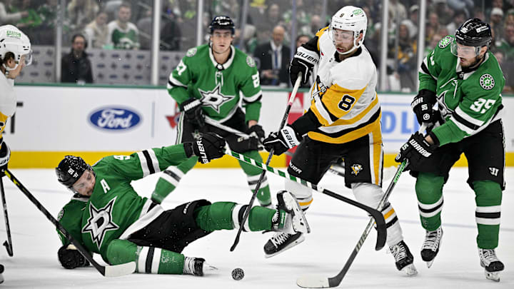 Mar 22, 2024; Dallas, Texas, USA; Dallas Stars center Tyler Seguin (91) is tripped up in front of center Matt Duchene (95) and Pittsburgh Penguins left wing Michael Bunting (8) during the third period at the American Airlines Center. Mandatory Credit: Jerome Miron-Imagn Images