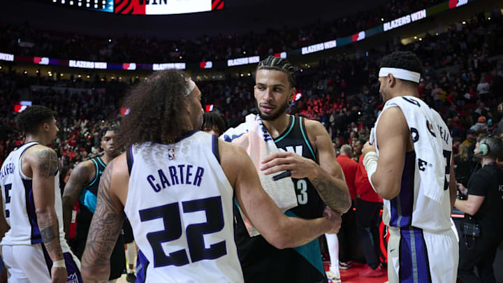 Apr 12, 2026; Portland, Oregon, USA; Portland Trail Blazers forward Toumani Camara (33) hugs Sacramento Kings guard Devin Carter (22) after a game at Moda Center. Mandatory Credit: Troy Wayrynen-Imagn Images