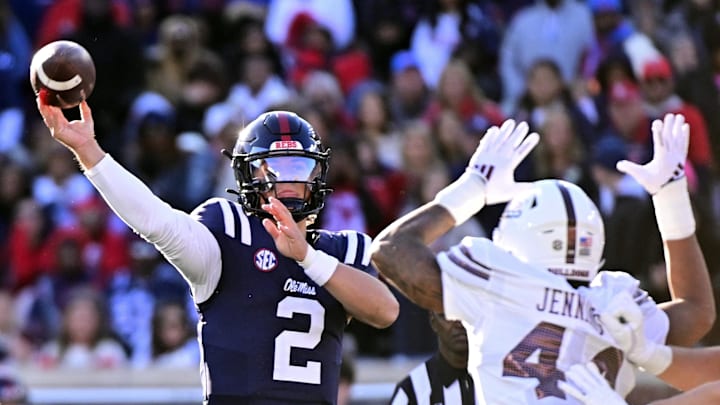 Nov 29, 2024; Oxford, Mississippi, USA;  Mississippi Rebels quarterback Jaxson Dart (2) looks to pass while defended by Mississippi State Bulldogs linebacker Branden Jennings (44) during the first quarter at Vaught-Hemingway Stadium. Mandatory Credit: Matt Bush-Imagn Images