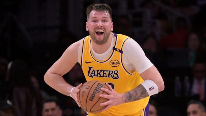 Feb 10, 2025; Los Angeles, California, USA; Los Angeles Lakers guard Luka Doncic (77) looks to make a long pass down court in the first half against the Utah Jazz at Crypto.com Arena. Mandatory Credit: Jayne Kamin-Oncea-Imagn Images