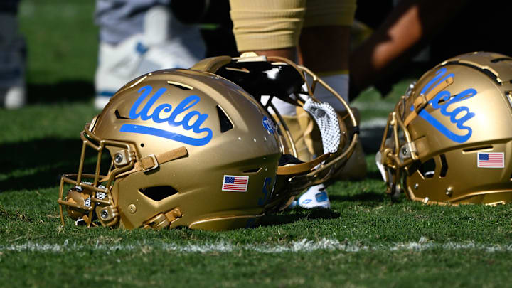Nov 30, 2024; Pasadena, California, USA; UCLA Bruins helmets during pregame warmups before playing the Fresno State Bulldogs at Rose Bowl. Mandatory Credit: Robert Hanashiro-Imagn Images