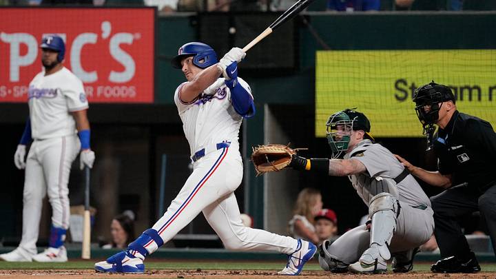 Aug 31, 2026; Arlington, Texas, USA;  Texas Rangers second baseman Justin Foscue (14) hits a solo home run against the Athletics during the fourth inning at Globe Life Field. Mandatory Credit: Raymond Carlin III-Imagn Images