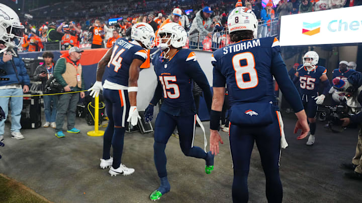 Dec 2, 2024; Denver, Colorado, USA; Denver Broncos wide receiver Courtland Sutton (14), linebacker Nik Bonitto (15), and quarterback Jarrett Stidham (8) before the game against the Cleveland Browns at Empower Field at Mile High. 