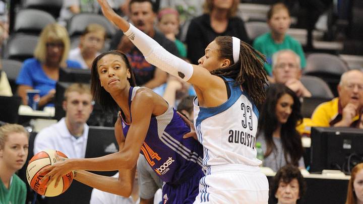 Jul 24, 2013; Minneapolis, MN, USA;  Phoenix Mercury guard DeWanna Bonner (24) looks to pass around Minnesota Score guard Seimone Augustus (33) in the first half at Target Center.  The Lynx defeated the Mercury 81-69.  Mandatory Credit: Marilyn Indahl-Imagn Images