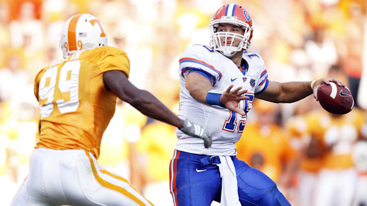 September 20, 2008;  Knoxville, TN, USA;  Florida Gators quarterback Tim Tebow (15) throws a touchdown pass to wide receiver Percy Harvin (not pictured) over top of Tennessee Volunteers defensive lineman Ben Martin (99) in the second half at Neyland Stadium. The Gators defeated the Volunteers 30-6. Mandatory Credit: Dale Zanine- Imagn Images