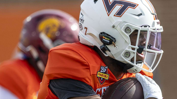 Jan 28, 2025; Mobile, AL, USA; National team running back Bhayshul Tuten of Virginia Tech (33) runs a play during Senior Bowl practice for the National team at Hancock Whitney Stadium. Mandatory Credit: Vasha Hunt-Imagn Images