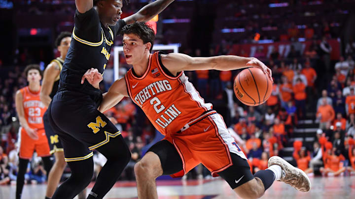 Feb 27, 2026; Champaign, Illinois, USA;  Illinois Fighting Illini guard Andrej Stojakovic (2) drives the ball against Michigan Wolverines guard L.J. Cason (2) during the first half at State Farm Center. Mandatory Credit: Ron Johnson-Imagn Images