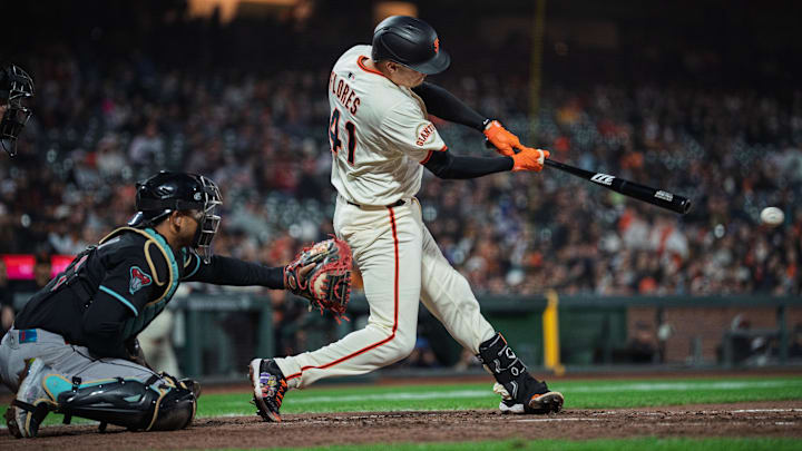 May 12, 2025; San Francisco, California, USA; San Francisco Giants first baseman Wilmer Flores (41) hits a single against the Arizona Diamondbacks during the seventh inning at Oracle Park.