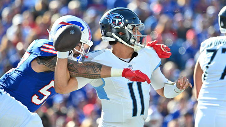 Oct 20, 2024; Orchard Park, New York, USA; Buffalo Bills defensive end AJ Epenesa (57)creates a fumble by Tennessee Titans quarterback Mason Rudolph (11) in the second quarter at Highmark Stadium. Mandatory Credit: Mark Konezny-Imagn Images