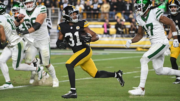 Oct 20, 2024; Pittsburgh, Pennsylvania, USA; Pittsburgh Steelers cornerback Beanie Bishop Jr. (31) returns an interception while being chased by New York Jets wide receiver Davante Adams (17) during the third quarter at Acrisure Stadium. Mandatory Credit: Barry Reeger-Imagn Images
