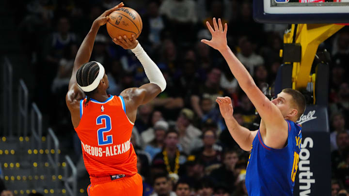 Dec 16, 2023; Denver, Colorado, USA; Oklahoma City Thunder guard Shai Gilgeous-Alexander (2) shoots the ball over Denver Nuggets center Nikola Jokic (15) in the fourth quarter at Ball Arena. Mandatory Credit: Ron Chenoy-Imagn Images