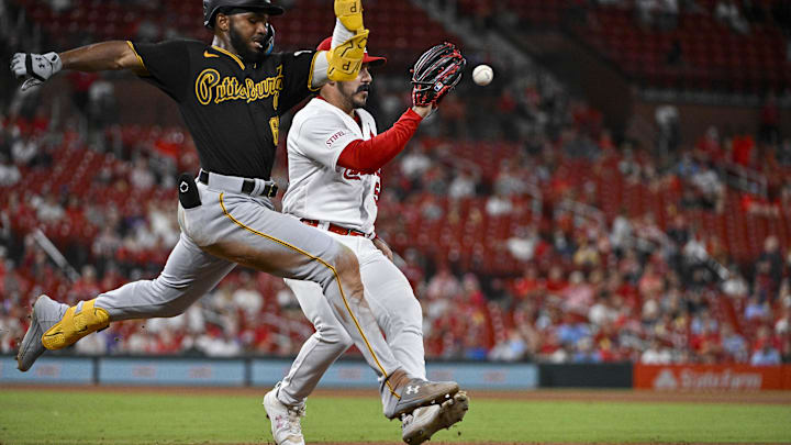 Pirates shortstop Liover Peguero (60) beats St. Louis Cardinals relief pitcher JoJo Romero (59) to first base during the tenth inning at Busch Stadium on Sept. 1, 2023.