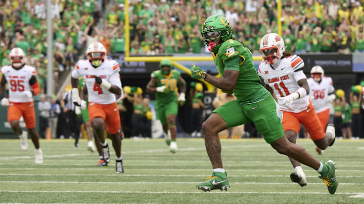 Sep 6, 2025; Eugene, Oregon, USA; Oregon Ducks wide receiver Dakorien Moore (1) scores a touchdown during the first half against the Oklahoma State Cowboys at Autzen Stadium. Mandatory Credit: Troy Wayrynen-Imagn Images Sep 6, 2025; Eugene, Oregon, USA; Oregon Ducks wide receiver Dakorien Moore (1) scores a touchdown during the first half against the Oklahoma State Cowboys at Autzen Stadium. Mandatory Credit: Troy Wayrynen-Imagn Images