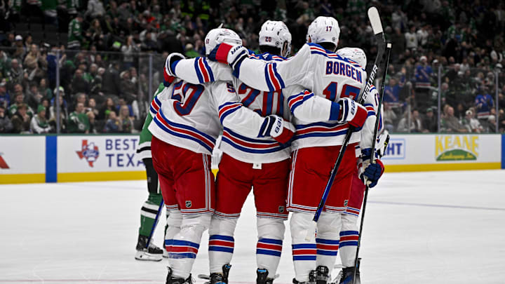 Dec 20, 2024; Dallas, Texas, USA; New York Rangers left wing Will Cuylle (50) and left wing Chris Kreider (20) and defenseman Will Borgen (17) celebrates an empty net goal scored by Kreider against the Dallas Stars during the third period at the American Airlines Center. Mandatory Credit: Jerome Miron-Imagn Images
