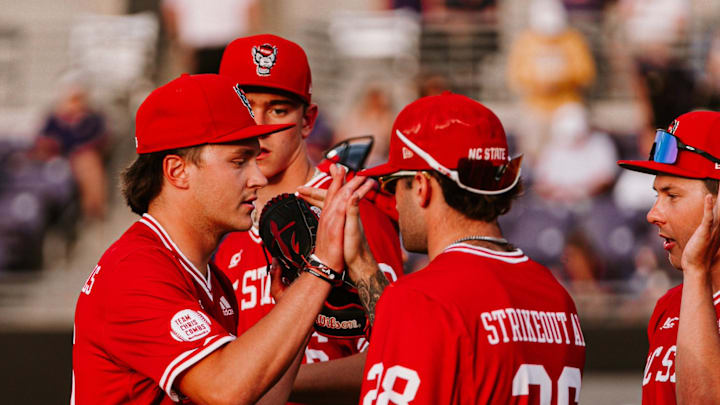 Freshman left-handed pitcher Luke Hemric (far left) high-fives his teammates during NC State's 10-3 victory over East Carolina in Greenville, N.C., on April 14, 2026. 