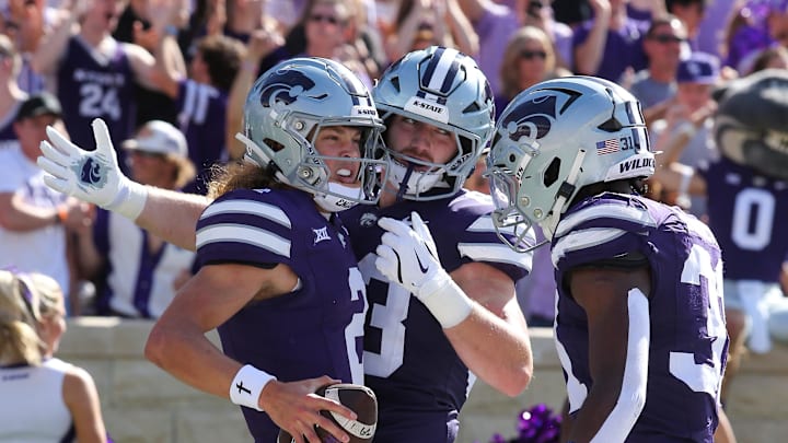 Sep 28, 2024; Manhattan, Kansas, USA; Kansas State Wildcats quarterback Avery Johnson (2) celebrates with running back Dylan Edwards (3) and running back DJ Giddens (31) after scoring a touchdown against the Oklahoma State Cowboys in the first quarter at Bill Snyder Family Football Stadium. Mandatory Credit: Scott Sewell-Imagn Images