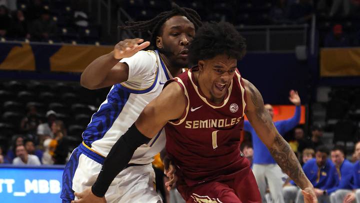 Mar 4, 2026; Pittsburgh, Pennsylvania, USA;  Florida State Seminoles guard Martin Somerville (1) dribbles the ball around Pittsburgh Panthers guard MacAri Moore (left) during the second half at the Petersen Events Center. Mandatory Credit: Charles LeClaire-Imagn Images