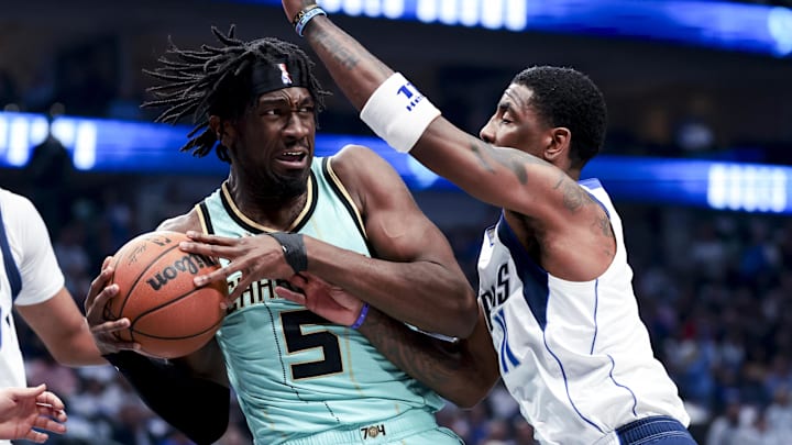 Feb 27, 2025; Dallas, Texas, USA;  Charlotte Hornets center Mark Williams (5) controls the ball as Dallas Mavericks guard Kyrie Irving (11) defends during the first half at American Airlines Center. Mandatory Credit: Kevin Jairaj-Imagn Images