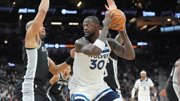 Jan 17, 2026; San Antonio, Texas, USA; Minnesota Timberwolves forward Julius Randle (30) keeps the ball from San Antonio Spurs forward Keldon Johnson (3) in the first half at Frost Bank Center. Mandatory Credit: Daniel Dunn-Imagn Images
