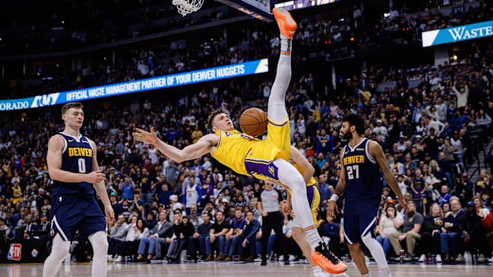 Mar 14, 2025; Denver, Colorado, USA: Los Angeles Lakers guard Dalton Knecht (4) falls to the court after a dunk in the fourth quarter against the Denver Nuggets at Ball Arena. Mandatory Credit: Isaiah J. Downing-Imagn Images Mar 14, 2025; Denver, Colorado, USA: Los Angeles Lakers guard Dalton Knecht (4) falls to the court after a dunk in the fourth quarter against the Denver Nuggets at Ball Arena. Mandatory Credit: Isaiah J. Downing-Imagn Images