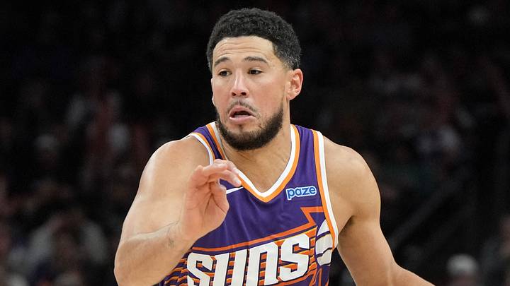 Oct 24, 2026; Phoenix, Arizona, USA;  Phoenix Suns guard Devin Booker (15) drives against the Golden State Warriors in the second half at Mortgage Matchup Center.  Mandatory Credit: Rick Scuteri-Imagn Images