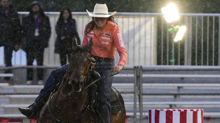 A barrel racer runs in the rain A barrel racer runs in the rain