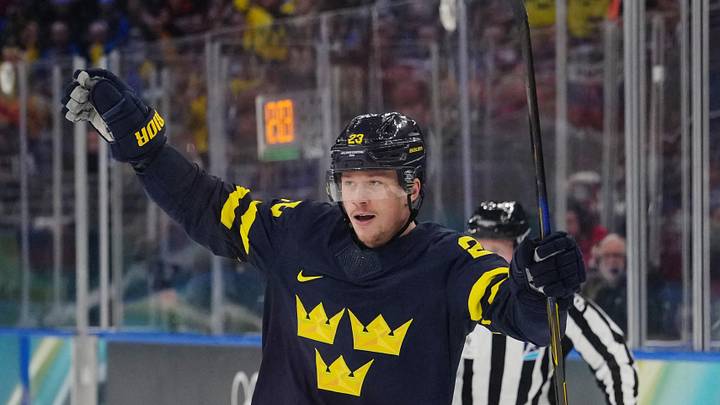 Feb 14, 2026; Milan, Italy; Lucas Raymond of Sweden celebrates after Elias Pettersson of Sweden scores their fourth goal during a Group B men's ice hockey game during the Milano Cortina 2026 Olympic Winter Games at Milano Santagiulia Ice Hockey Arena. Mandatory Credit: James Lang-Imagn Images Feb 14, 2026; Milan, Italy; Lucas Raymond of Sweden celebrates after Elias Pettersson of Sweden scores their fourth goal during a Group B men's ice hockey game during the Milano Cortina 2026 Olympic Winter Games at Milano Santagiulia Ice Hockey Arena. Mandatory Credit: James Lang-Imagn Images